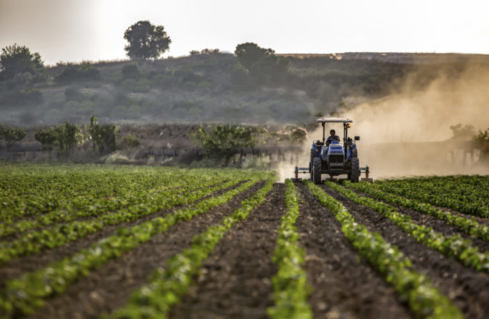 Image of tractor and farmer in the field