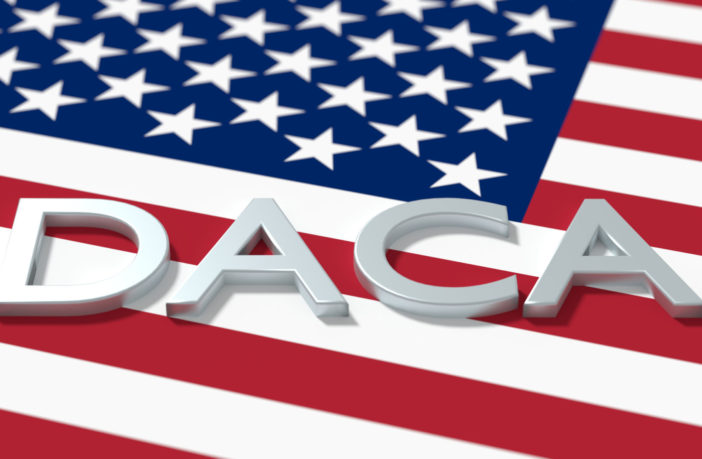 The word DACA on top of United States Flag