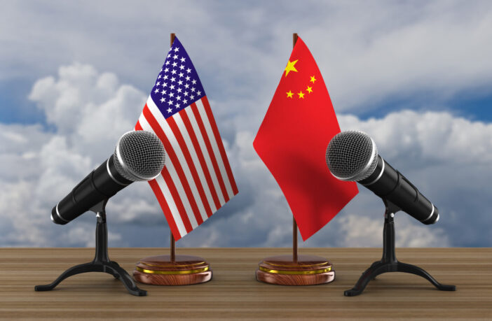 United States and China flag with two microphones