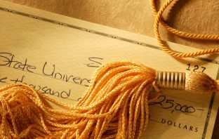 Gold tassel on a check written for college tuition