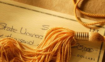 Gold tassel on a check written for college tuition