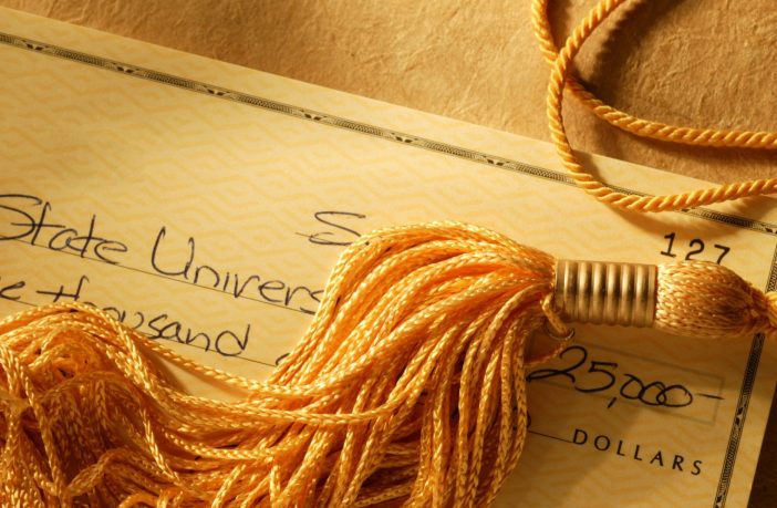 Gold tassel on a check written for college tuition